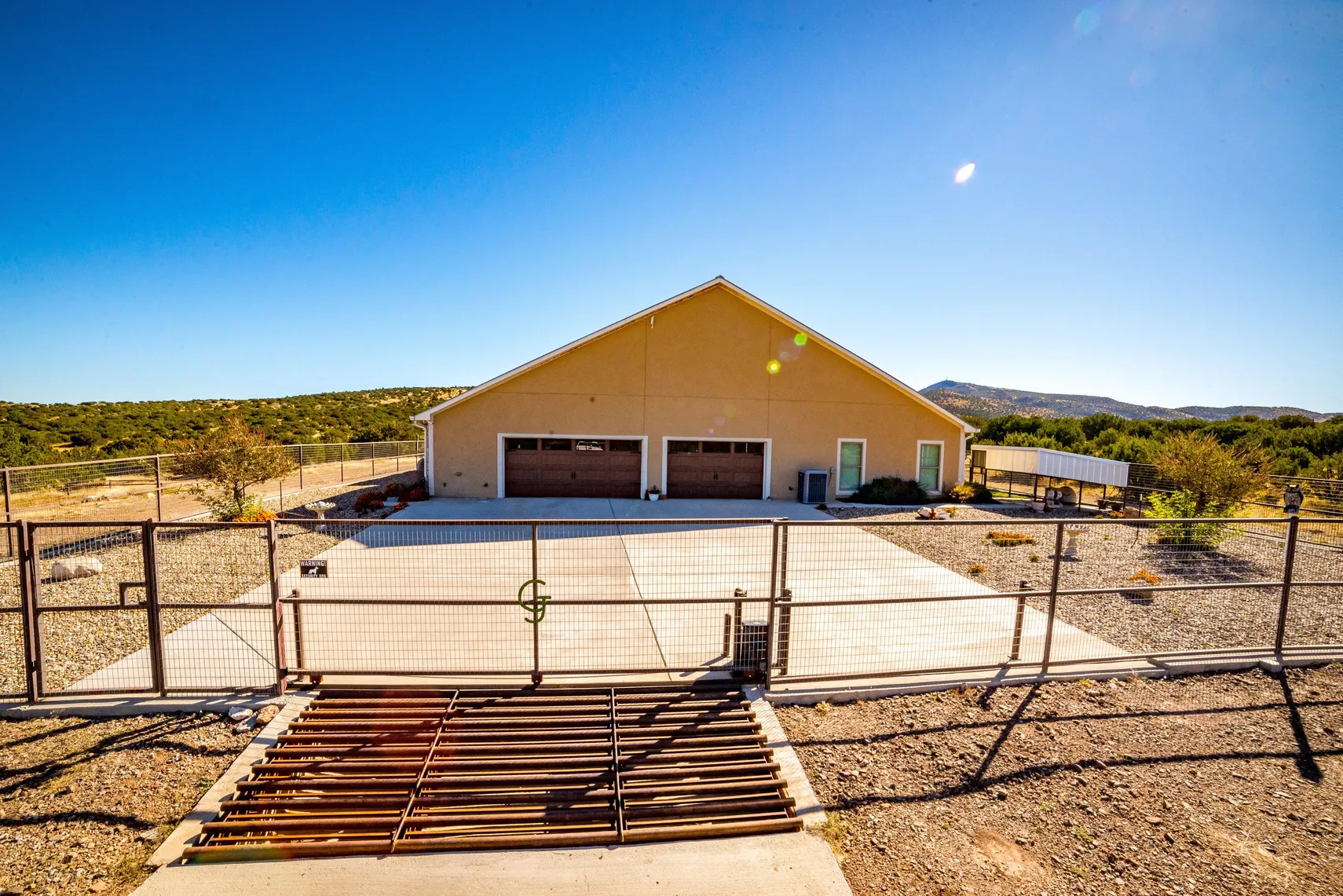 Garage side of the home with branded entry gate