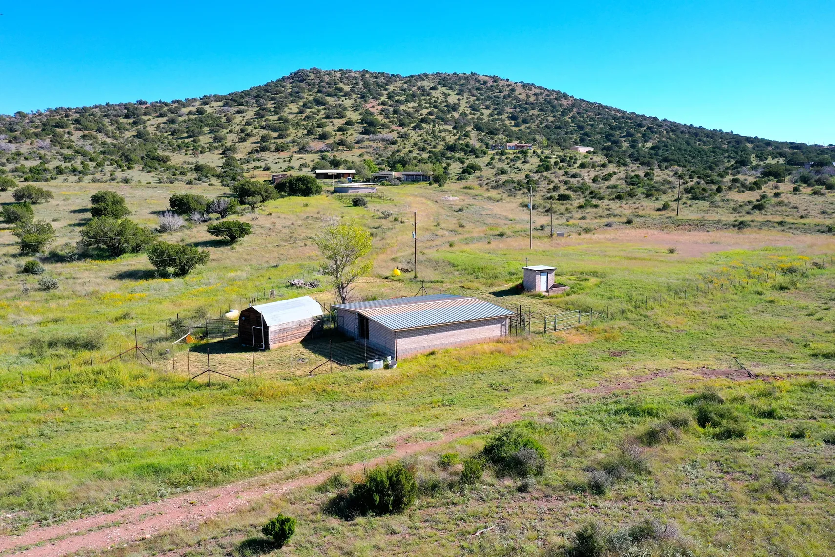 Outbuilding previously used as a dog kennel with hillside backdrop