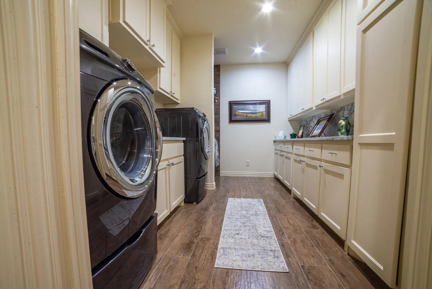 Spacious laundry room with built-in cabinetry