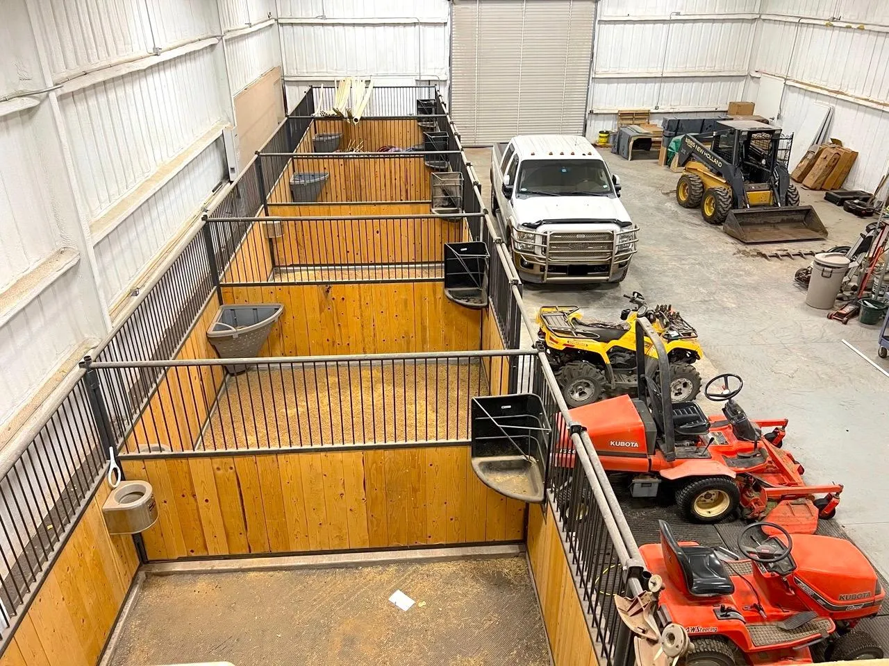 Inside the barn: five matted stalls and equipment bay